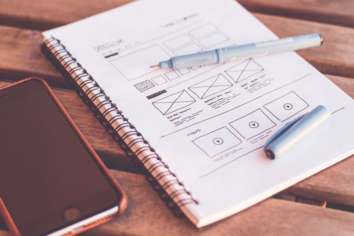 Landing page versus full website — sketches of a one-page layout next to a multi-page sitemap
