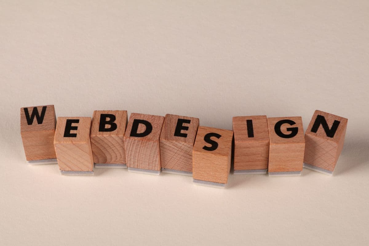 Deciding when to redesign a website — reviewing an outdated business site on a laptop and phone