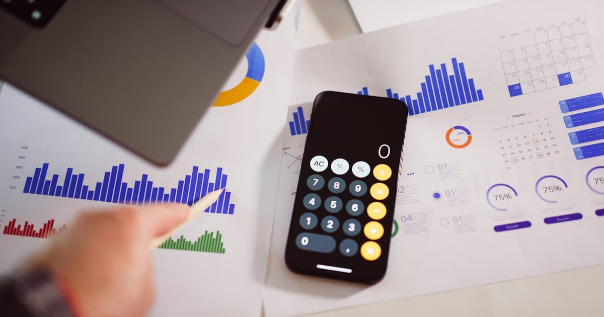 Planning a website budget in Malaysia — calculator, cost charts and a laptop on a desk